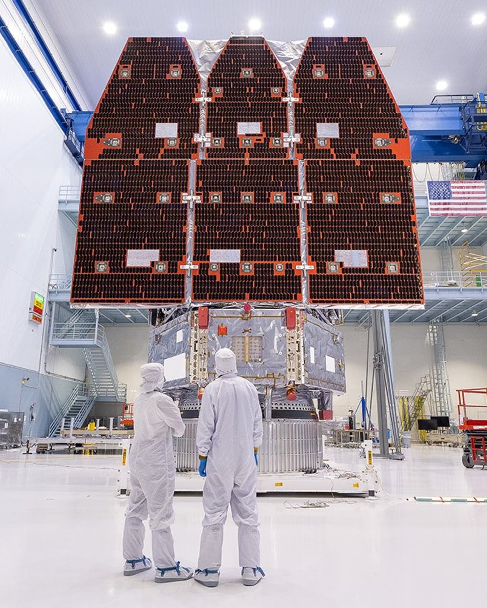 NASA's Roman Space Telescope in a clean room with its solar panels deployed.